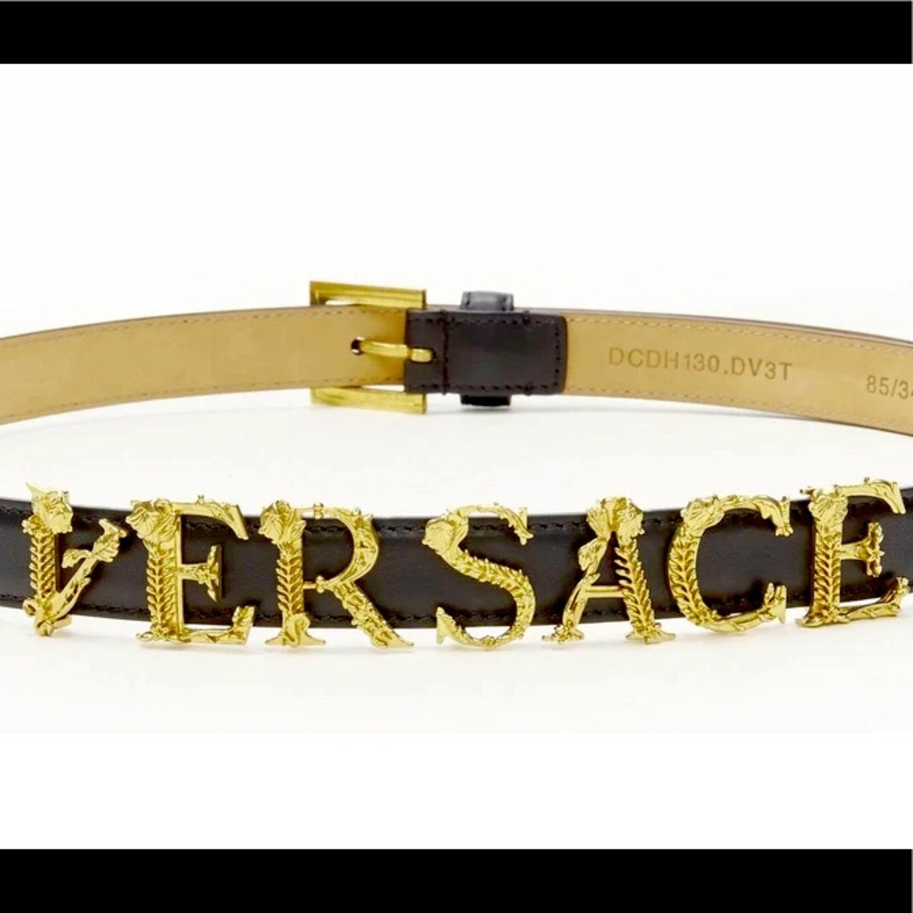 Gold letters Versace logo black belt.